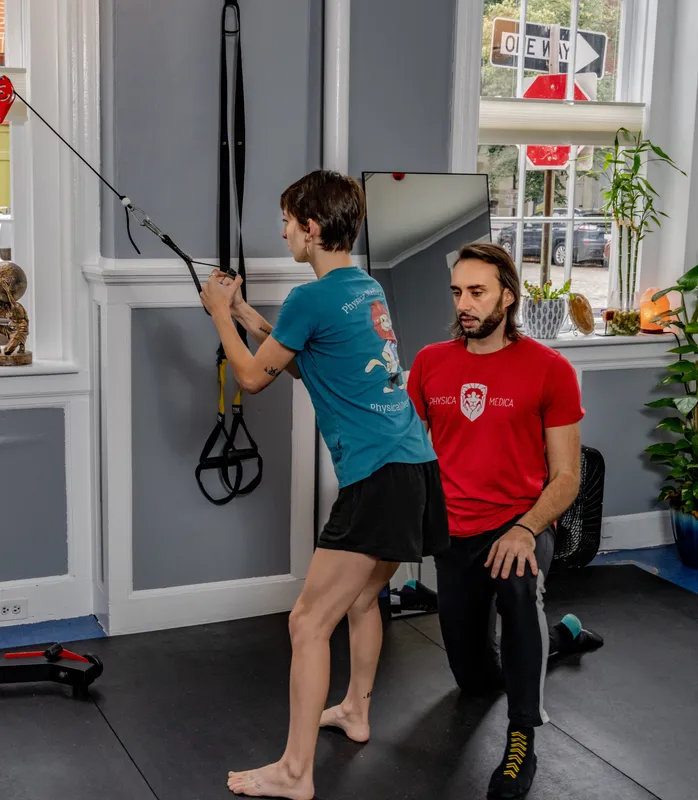 Practitioner performing dry needling or neural tension release technique on client's leg during treatment